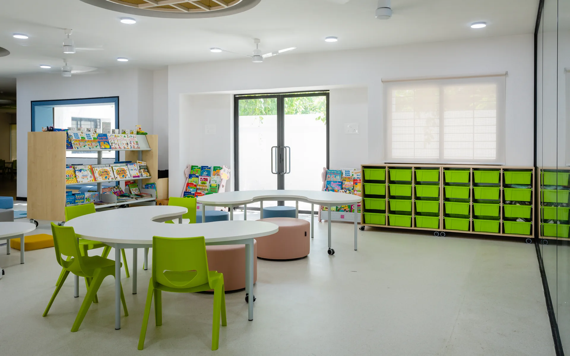A dynamic learning area featuring flexible furniture, accessible storage, vibrant colors, and varied seating arrangements, creating an interactive environment that supports creativity and collaborative learning.