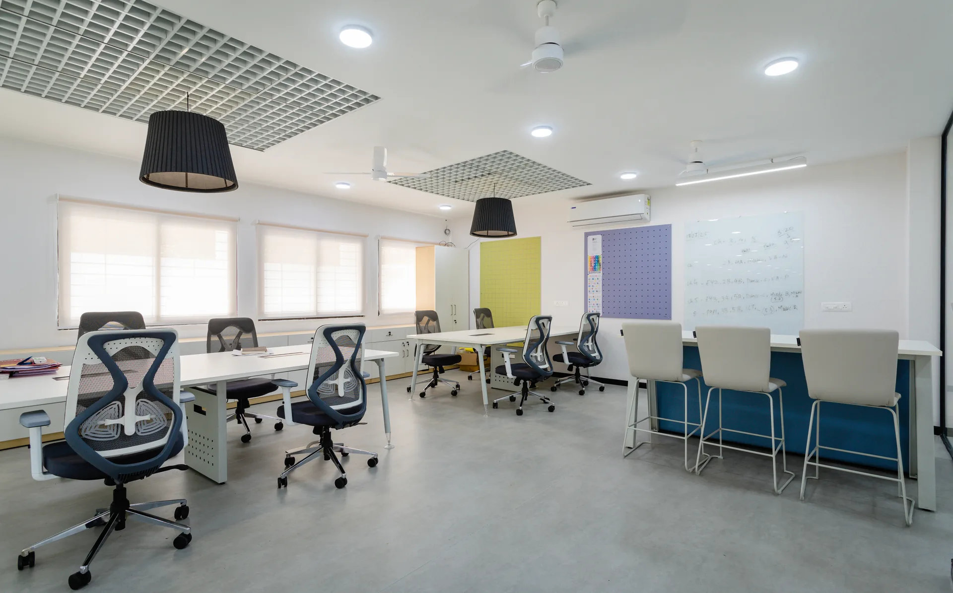 A thoughtfully designed staff room featuring ergonomic seating, collaborative worktables, ample storage, and abundant natural light, creating a comfortable and efficient workspace for educators.
