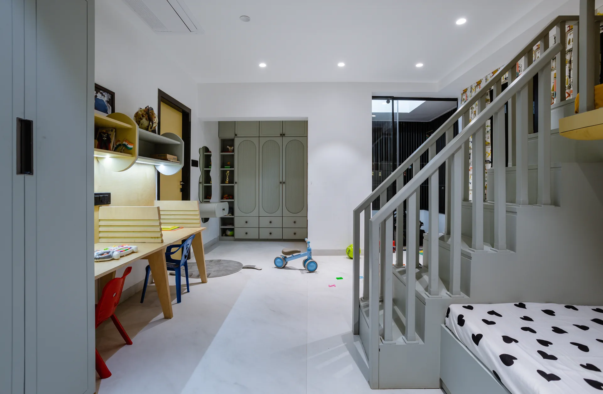 A playful kids’ room featuring a custom bunk bed, dedicated study zone, smart storage, and cheerful accents, creating a functional space for rest, learning, and play.